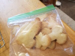 A zip-top plastic bag filled with sugar cookies that are sort of shaped like bones but really look more penis-like.